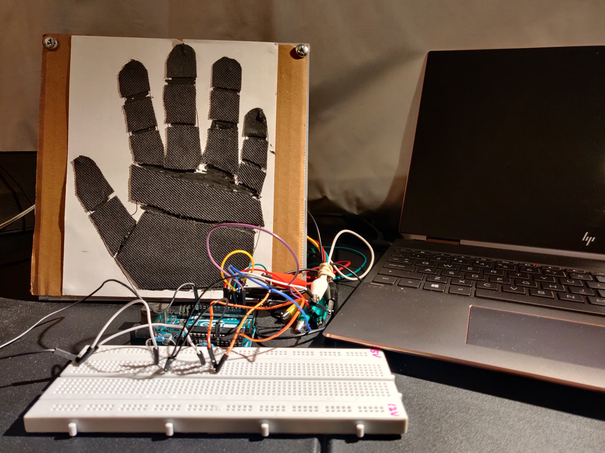 Conductive-fabric hand sensors wired to an Arduino on a breadboard